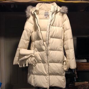 White winter jacket, gloves and scarf.